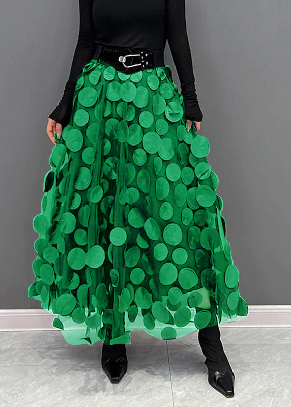 Women's chic polka dot patchwork maxi skirt on hanger, displaying its elegant and playful design.