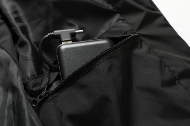 Sleek black unisex heated jacket, water-repellent & lightweight, perfect for winter wear.