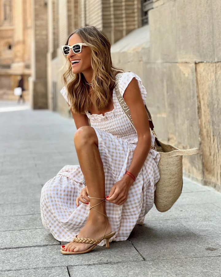 Beige smocked maxi dress for women, ideal summer beachwear or versatile everyday fashion.