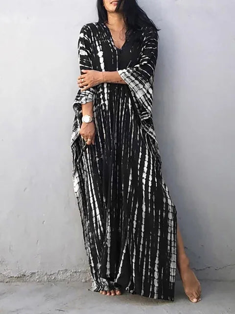 Woman enjoying the beach in a stylish flowy caftan maxi dress, embodying summer freedom.