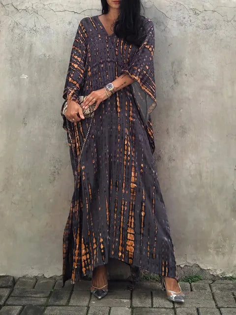 Back view of a women's elegant flowy caftan maxi dress, showcasing its beautiful drape.