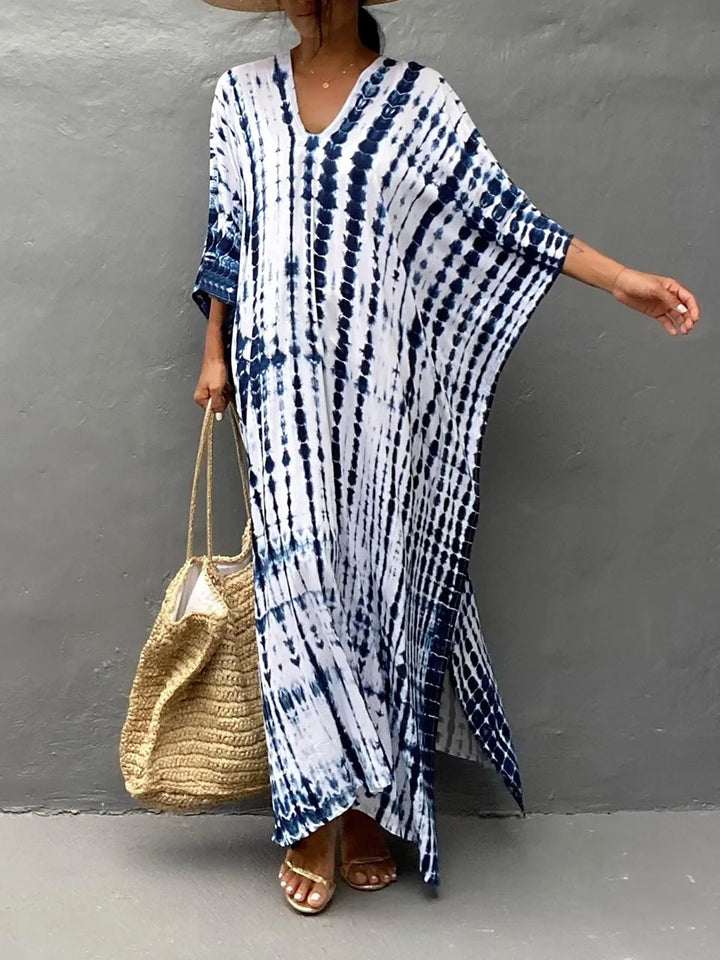 Side profile of a woman wearing a loose-fit flowy caftan maxi dress, ideal for summer.