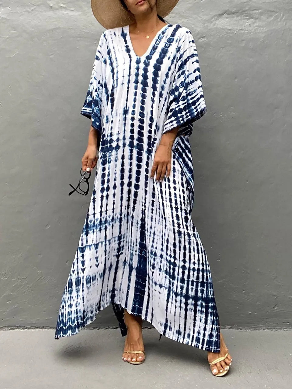 Close-up of the elegant patterned fabric on a women's flowy caftan maxi summer dress.