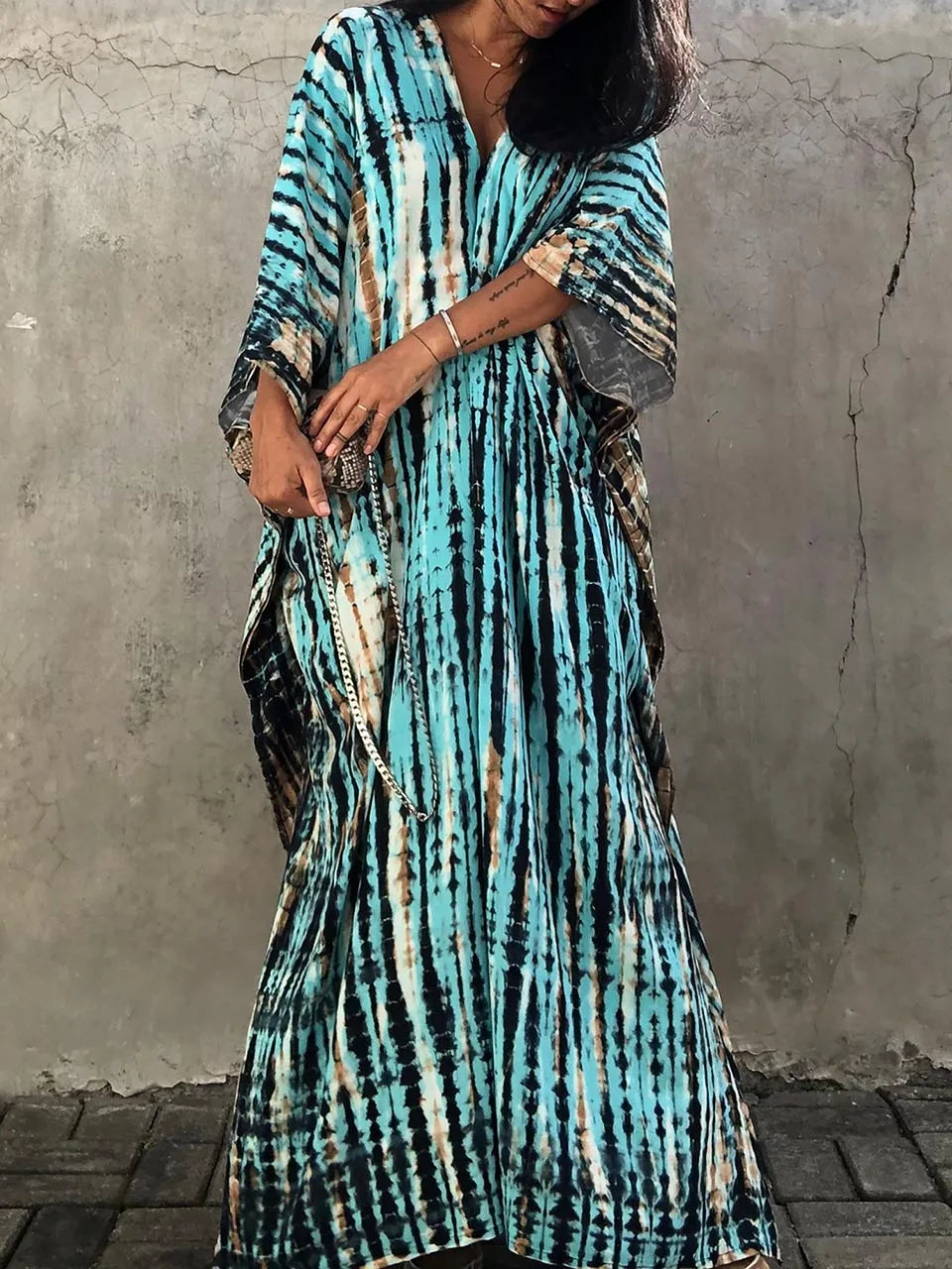 Woman relaxing poolside in a chic women's flowy caftan maxi dress, resort wear perfection.