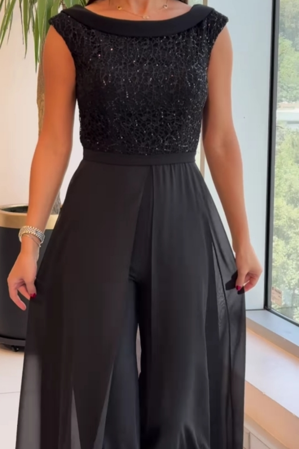 Fashionable women's sleeveless black sequin jumpsuit with a comfortable straight-leg fit for special events.