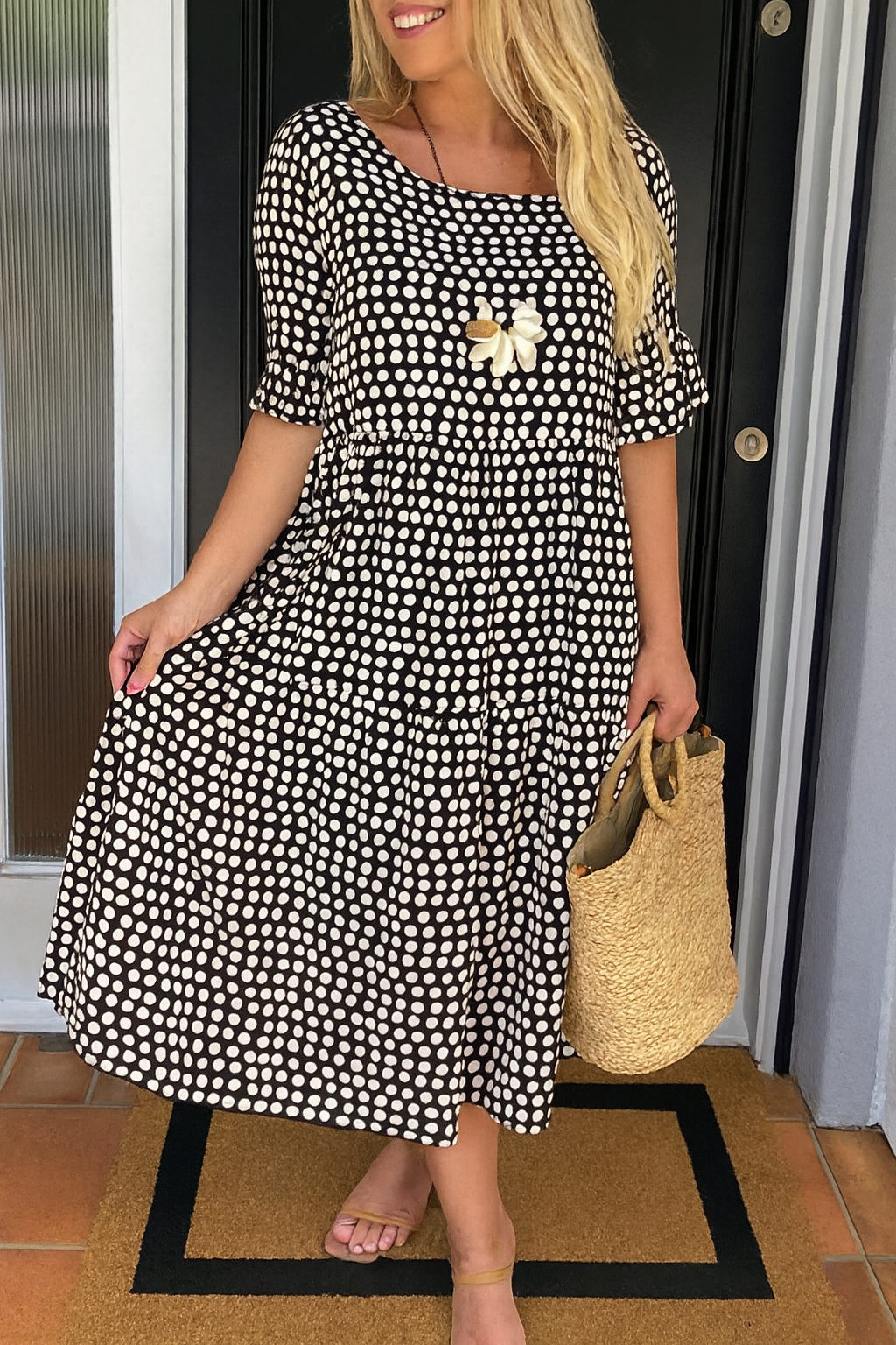 Classic black short-sleeve midi dress for women. Elegant round neck design.