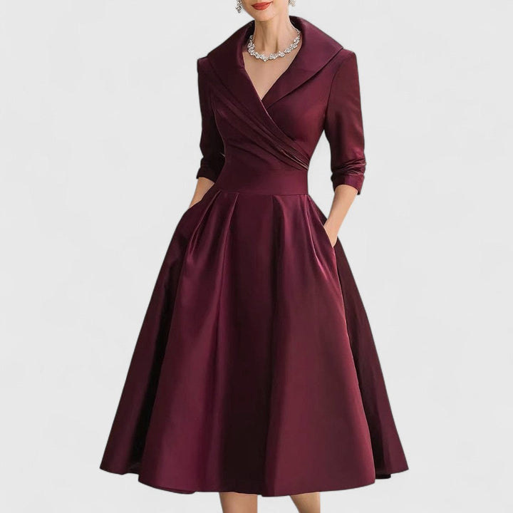 Black elegant women's midi dress with 3/4 sleeves, V-neckline, flattering silhouette, and pockets.