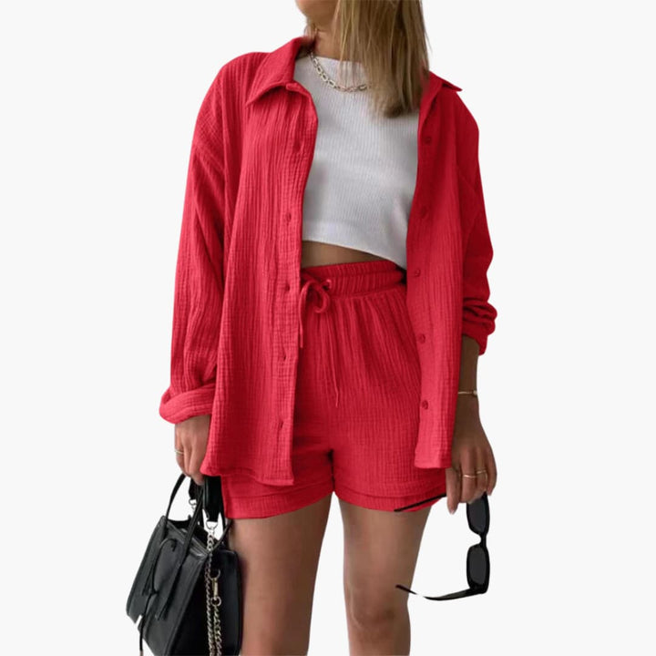 Back view of women's stylish three-piece set with a relaxed shirt, crop top, and casual high-waist shorts.