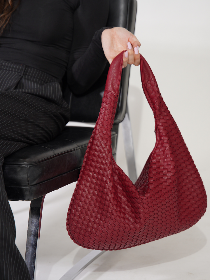 Fashion-forward women's one shoulder crossbody. Premium vegan leather accessory.