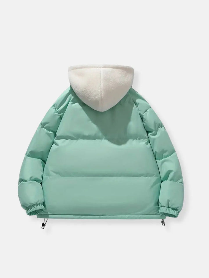 Comfortable women's hooded puffer jacket, ideal for cold weather, travel, & outdoor chic.