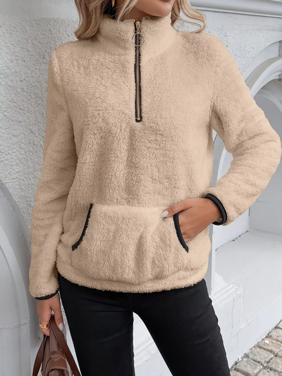Fashionable women's half-zip pullover, offering cozy comfort & relaxed style.
