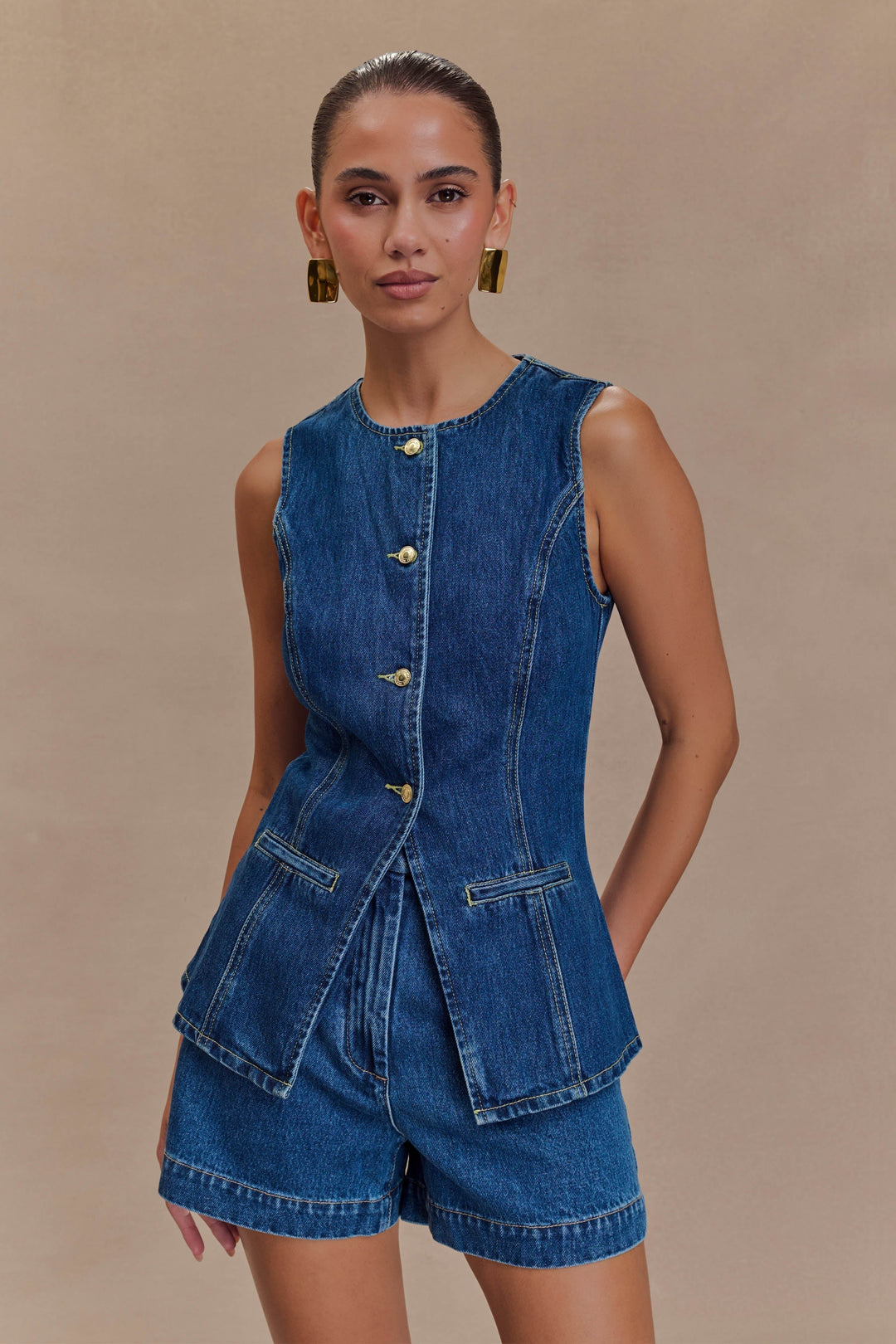 Women's blue denim two-piece set featuring a sleeveless top and high-waisted shorts, perfect for summer casual wear.