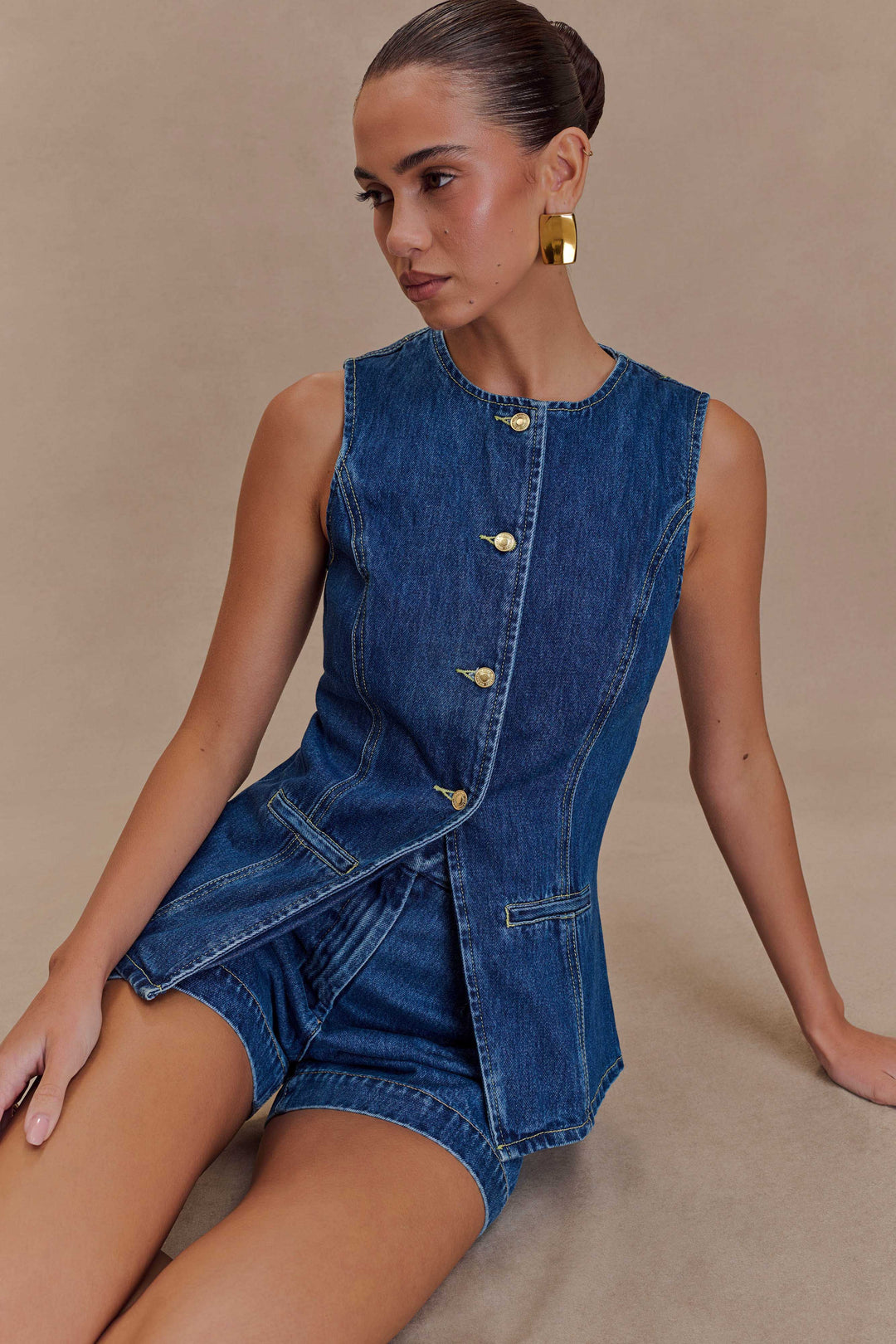 Casual women's blue denim two-piece set: a comfortable sleeveless top and high-waist shorts for summer outings.
