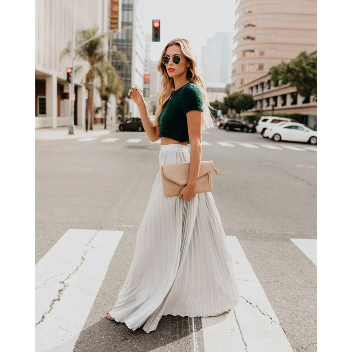 Stylish women's high-waist pleated midi skirt with a long, flowy design.
