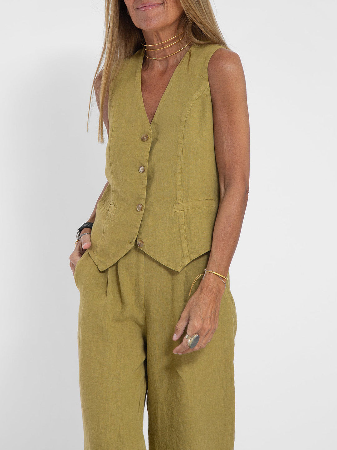 Close-up of the V-neck detail on the elegant women's sleeveless top, part of a two-piece set.