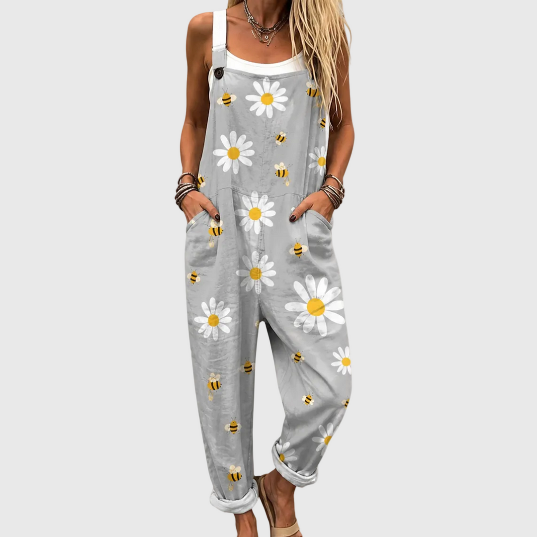 Light gray women's dungarees with soft daisy & bee print. Loose fit casual jumpsuit, perfect for comfortable summer style.