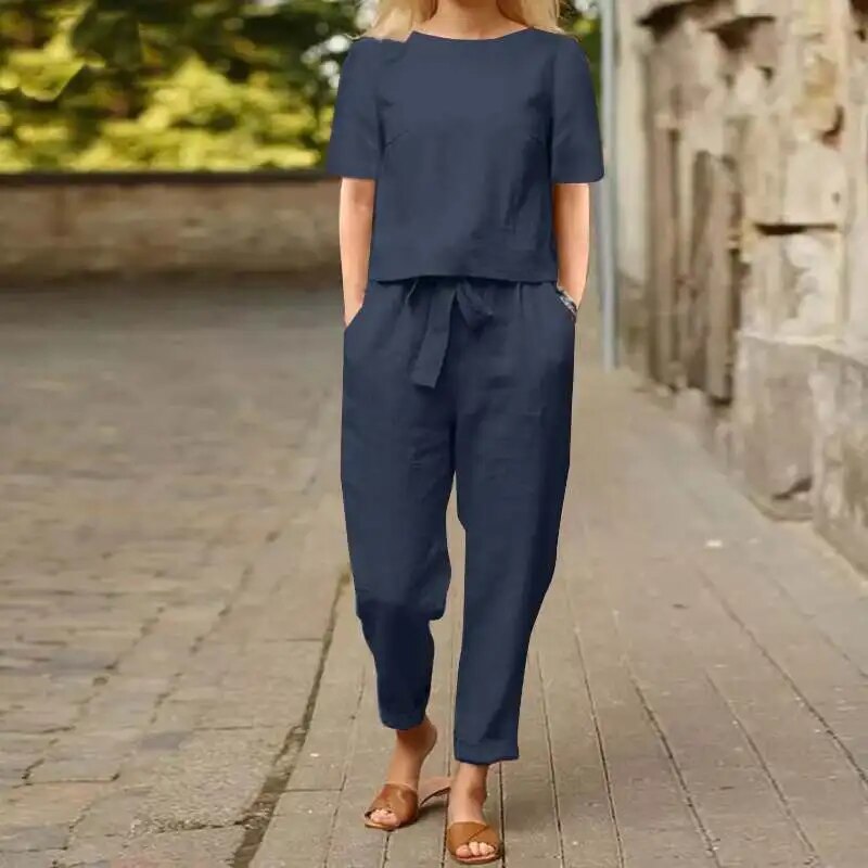 Stylish women's linen two-piece set for summer. Includes top & pants, ideal for casual, elegant, or beachwear.