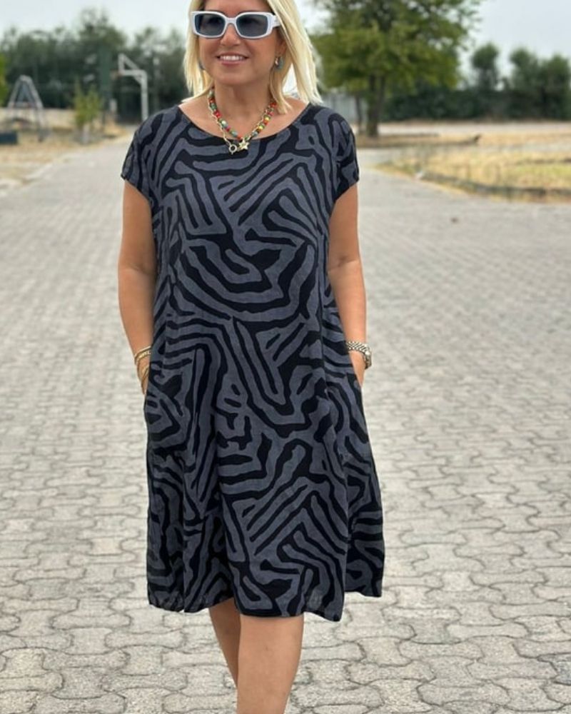 Comfortable women's round neck midi dress. Versatile for summer, casual wear, or elegant outings.