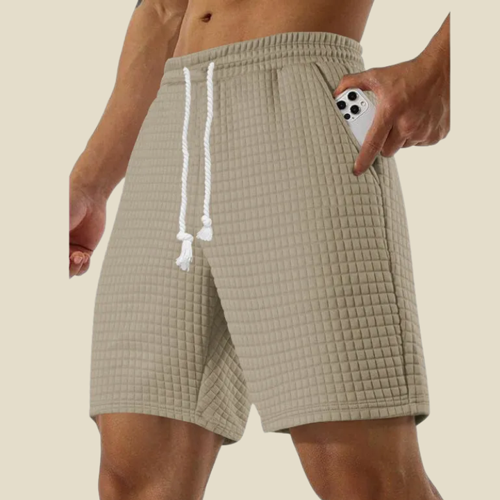 Comfortable men's waffle-knit shorts with an elastic waist & relaxed fit. Stylish and soft for everyday wear.