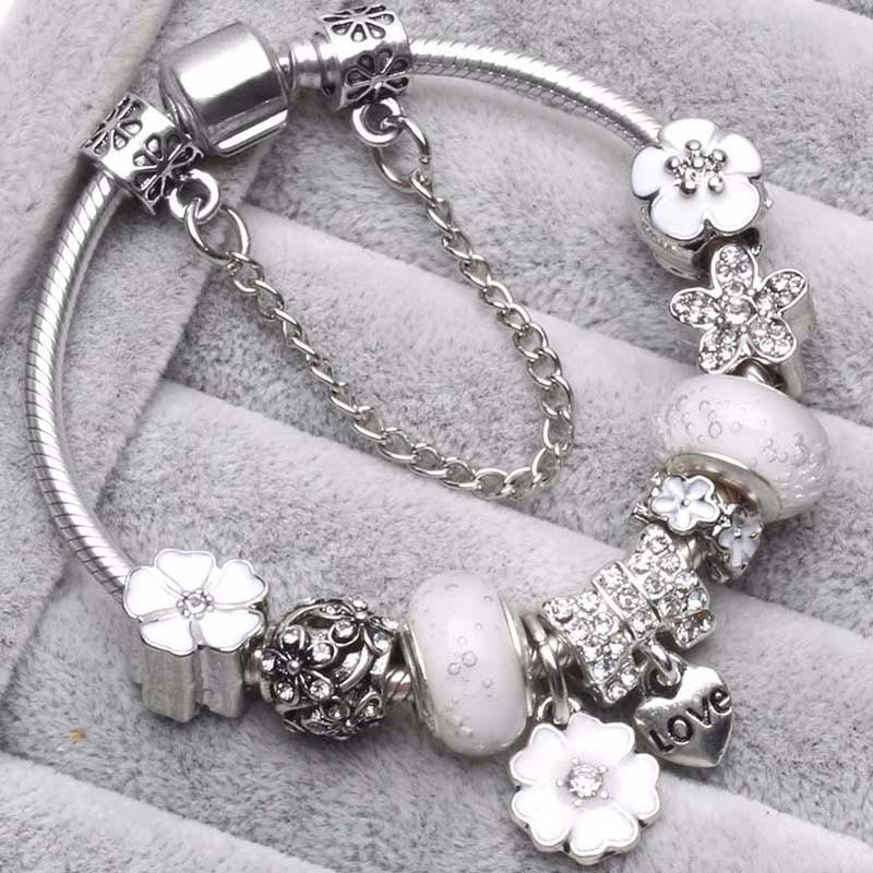 Women's delicate peach blossom charm bracelet, elegant floral jewelry accessory for versatile everyday wear.