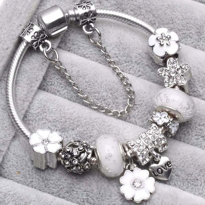 Women's delicate peach blossom charm bracelet, elegant floral jewelry accessory for versatile everyday wear.