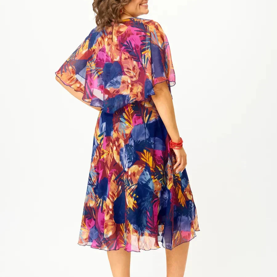 Vibrant print plus size women's summer midi dress, comfortable flowing A-line, elegant for warm weather vacation.