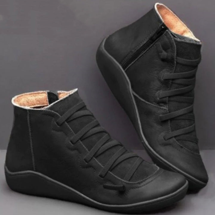 Durable women's PU leather orthopaedic ankle boots with side zip for comfort & style.