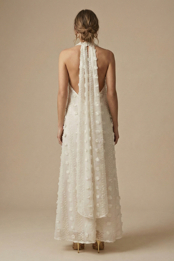 Chic women's maxi halter dress with intricate 3D floral appliqué, an elegant backless design for special occasions.