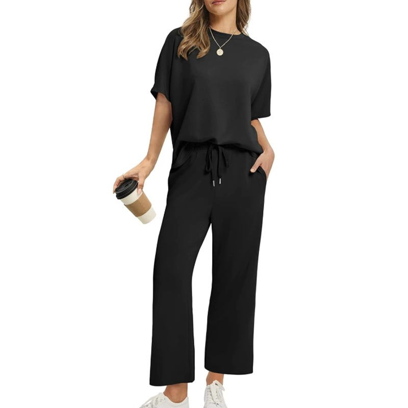 Stylish women's comfortable ribbed loungewear set with relaxed fit top & ankle trousers, perfect for travel or casual wear.