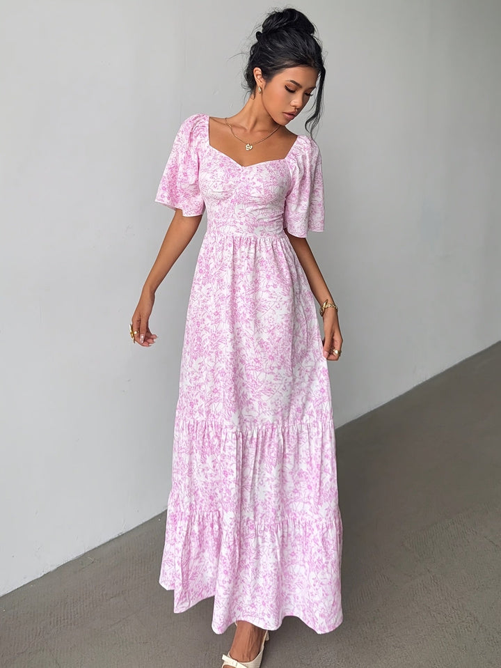 Elegant women's floral maxi dress with sweetheart neckline & tiered skirt, perfect for summer occasions.