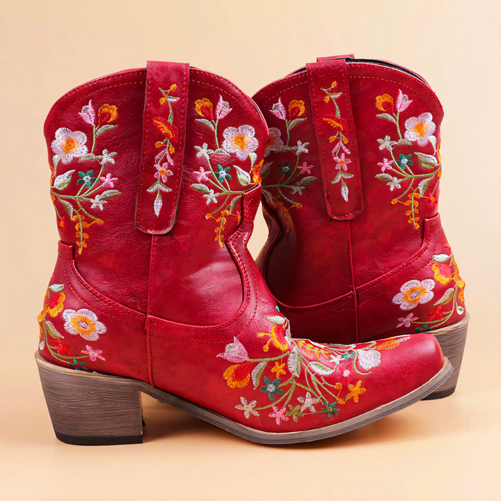 Women's vintage weatherproof cowgirl boots with intricate embroidery, perfect for outdoor festivals and all-weather style.