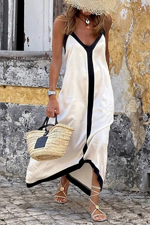Elegant women's white V-neck spaghetti strap maxi dress, perfect for summer vacations or beach parties. Flowy & comfortable.