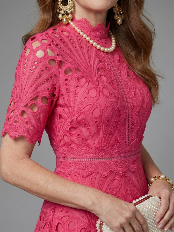 Stunning pink eyelet lace midi dress with a defined waist & short sleeves, ideal for cocktail or summer parties.