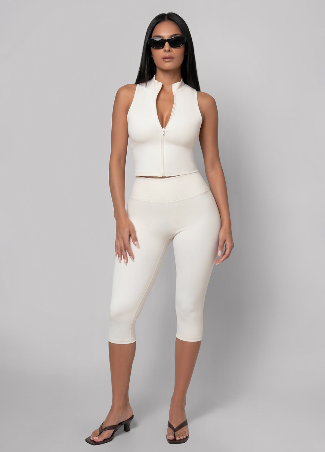 Ivory high-waisted capri leggings for women, perfect for Pilates & studio comfort. Flexible athleisure wear.