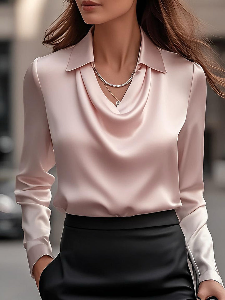 Refined long-sleeve women's blouse, satin fabric, and an elegant draped neckline. Ideal for formal wear.