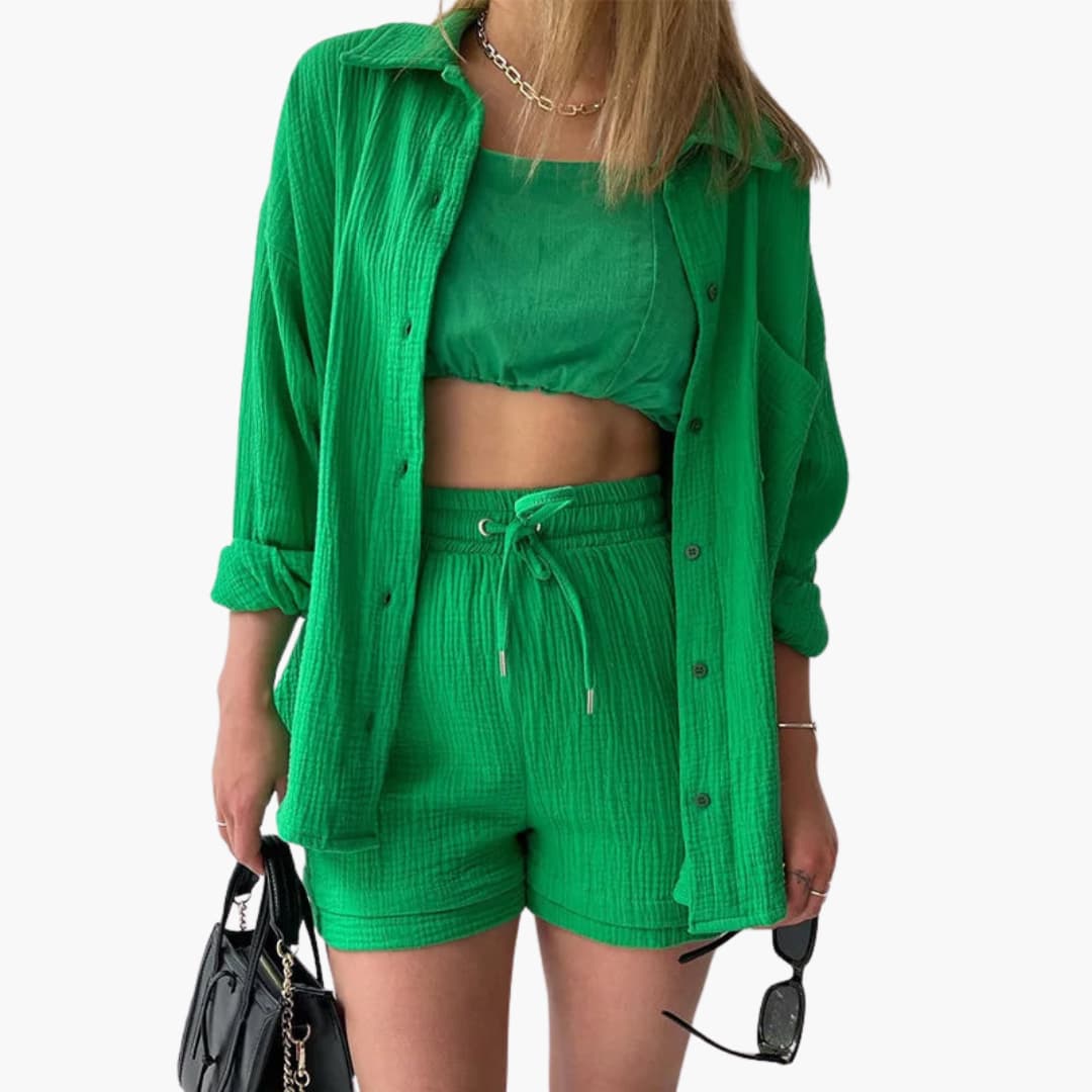 Comfy women's three-piece lounge set: relaxed button shirt, soft crop top & high-waisted shorts. Summer fashion.