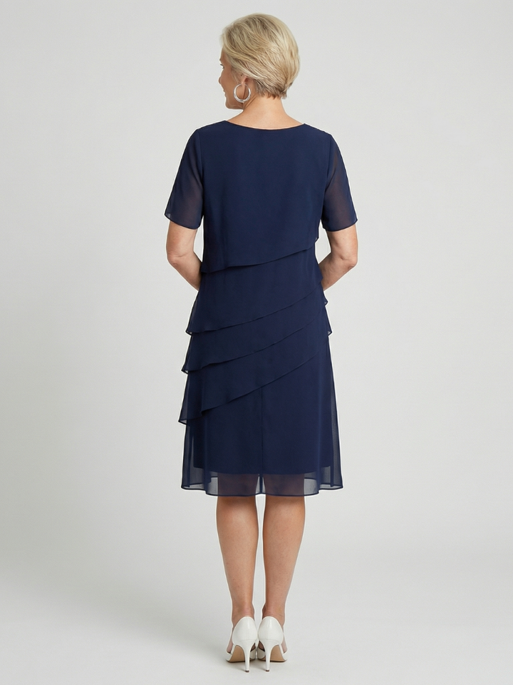Knee-length women's dress with a relaxed fit, short sleeves, and soft contour for casual wear.