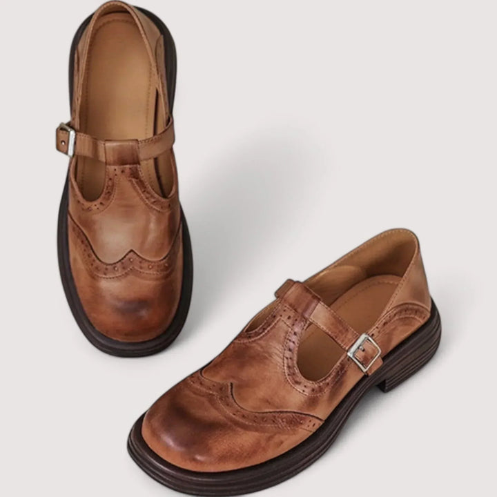 Elegant black Mary Jane women's shoes with classic brogue detailing, perfect for vintage-inspired outfits.
