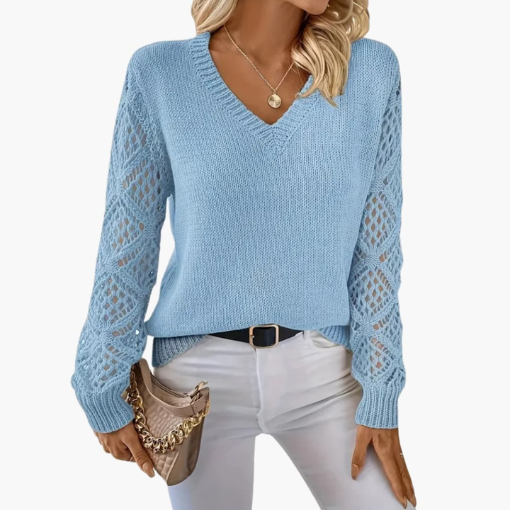 Stylish women's V-neck jumper with unique open sleeve detail, a versatile knitted top for any season.