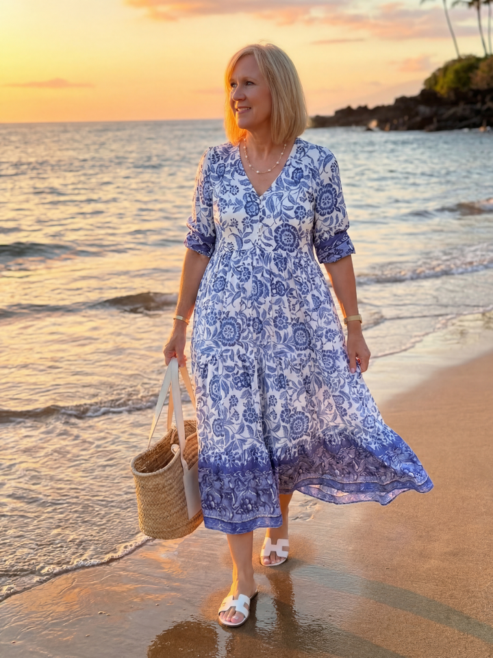 Elegant women's blue floral midi dress with V-neckline & elbow sleeves, perfect for summer casual wear.