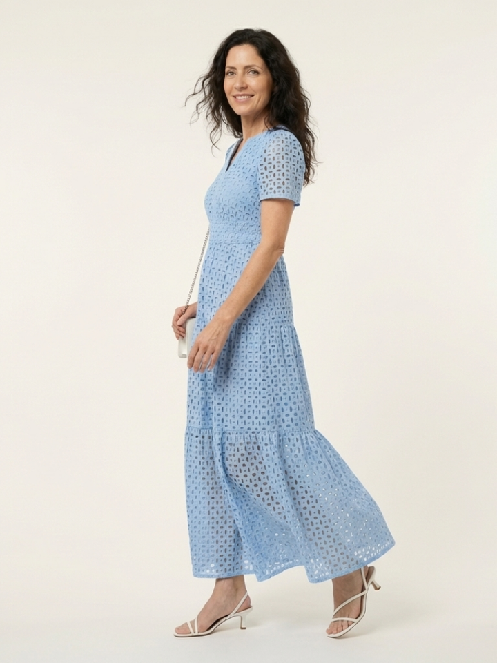 Elegant sky blue eyelet V-neck midi dress featuring short sleeves and a stylish tiered skirt.