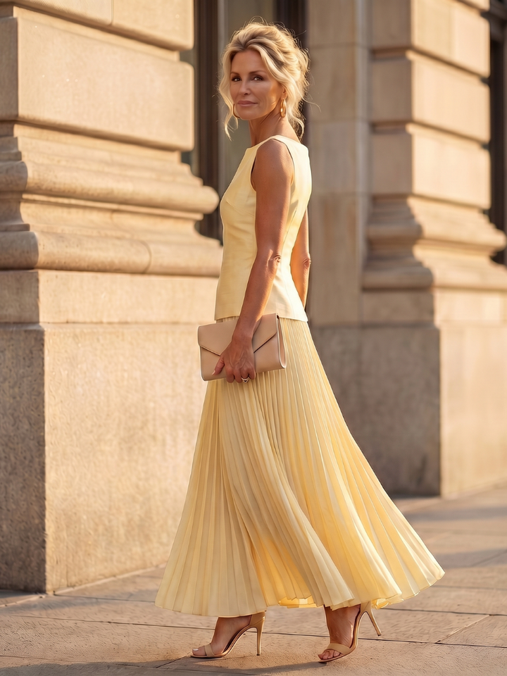 Women's fashion set: sleeveless structured top paired with a chic pleated maxi skirt for an elegant look.