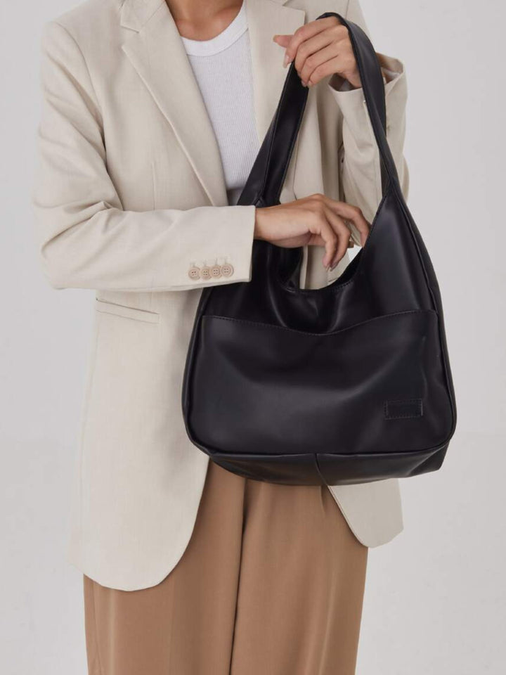 Stylish women's vegan leather shoulder bag. Versatile everyday tote, perfect for work, school & essentials.