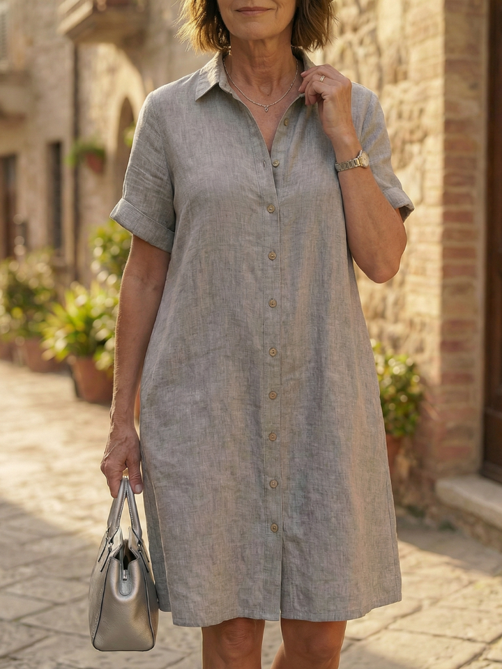 Casual knee-length women's dress, breezy fabric & functional buttons for summer walks.
