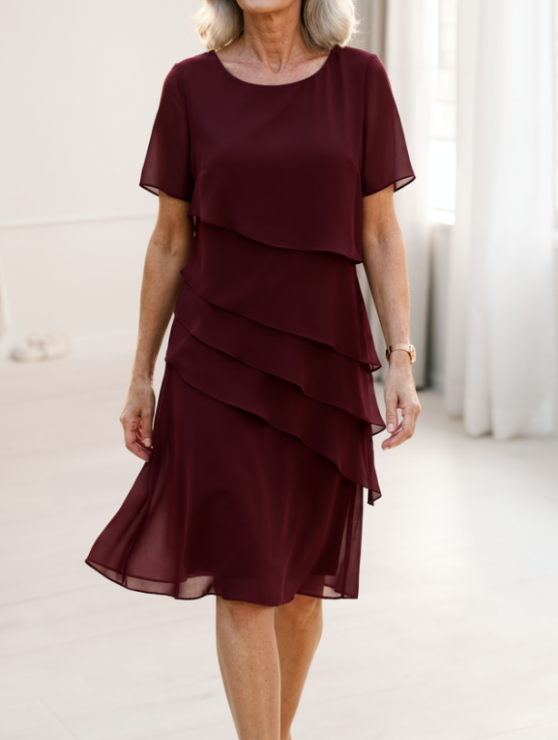 Elegant women's midi dress with feminine ruffles, a flowing design & sheer sleeves for sophisticated style.