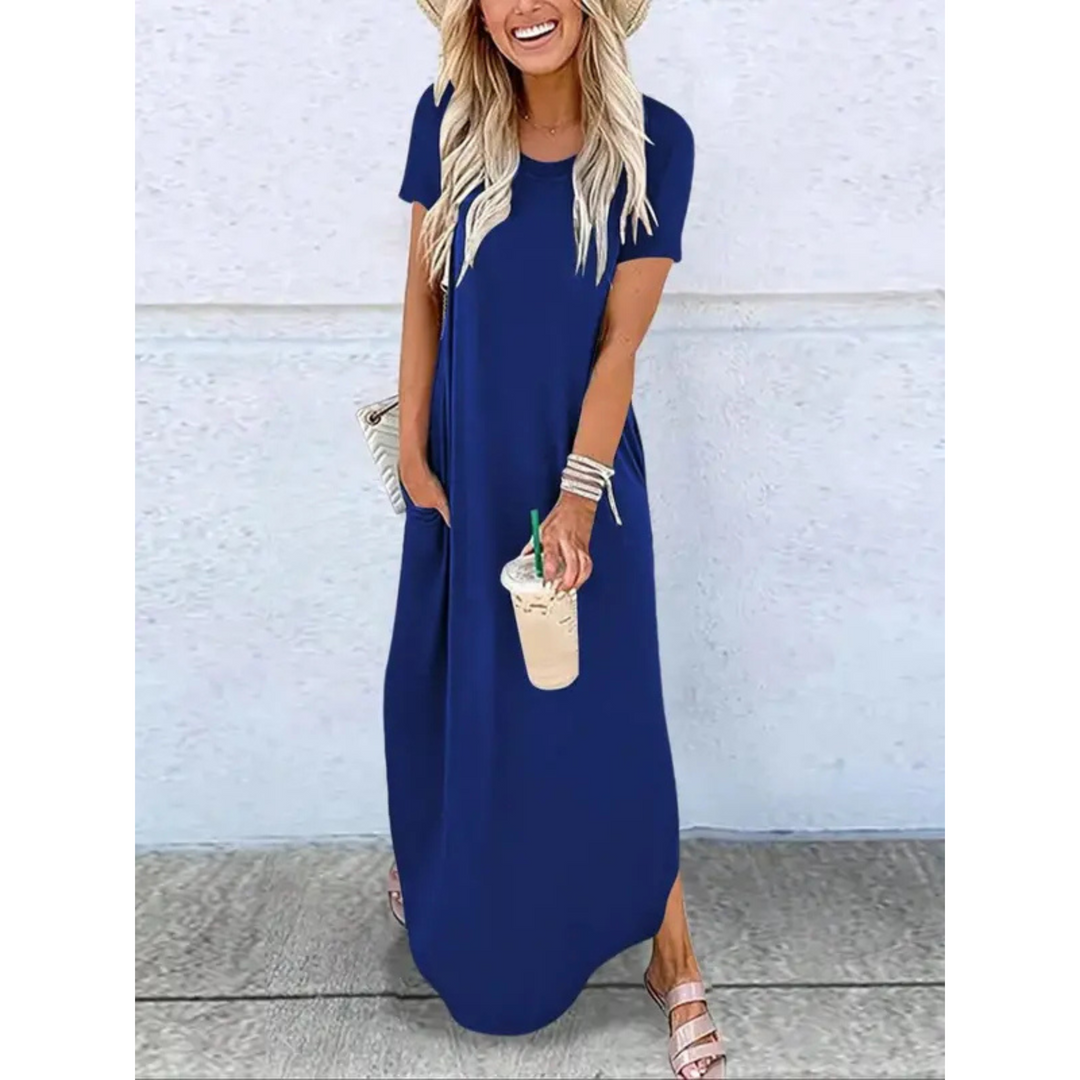 Flowy women's summer maxi dress featuring practical side pockets, a round neck, and short sleeves.