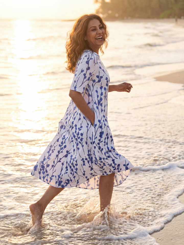 Elegant women's a-line floral midi dress, short sleeve, with pockets, ideal for Hawaii style summer fashion.