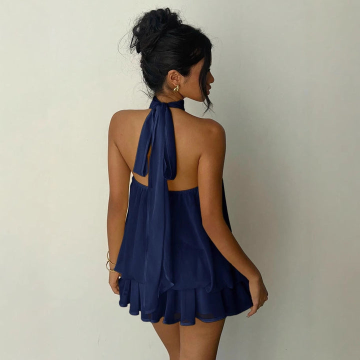 Lightweight women's tiered ruffle mini dress with a halter neck, perfect for warm weather comfort.