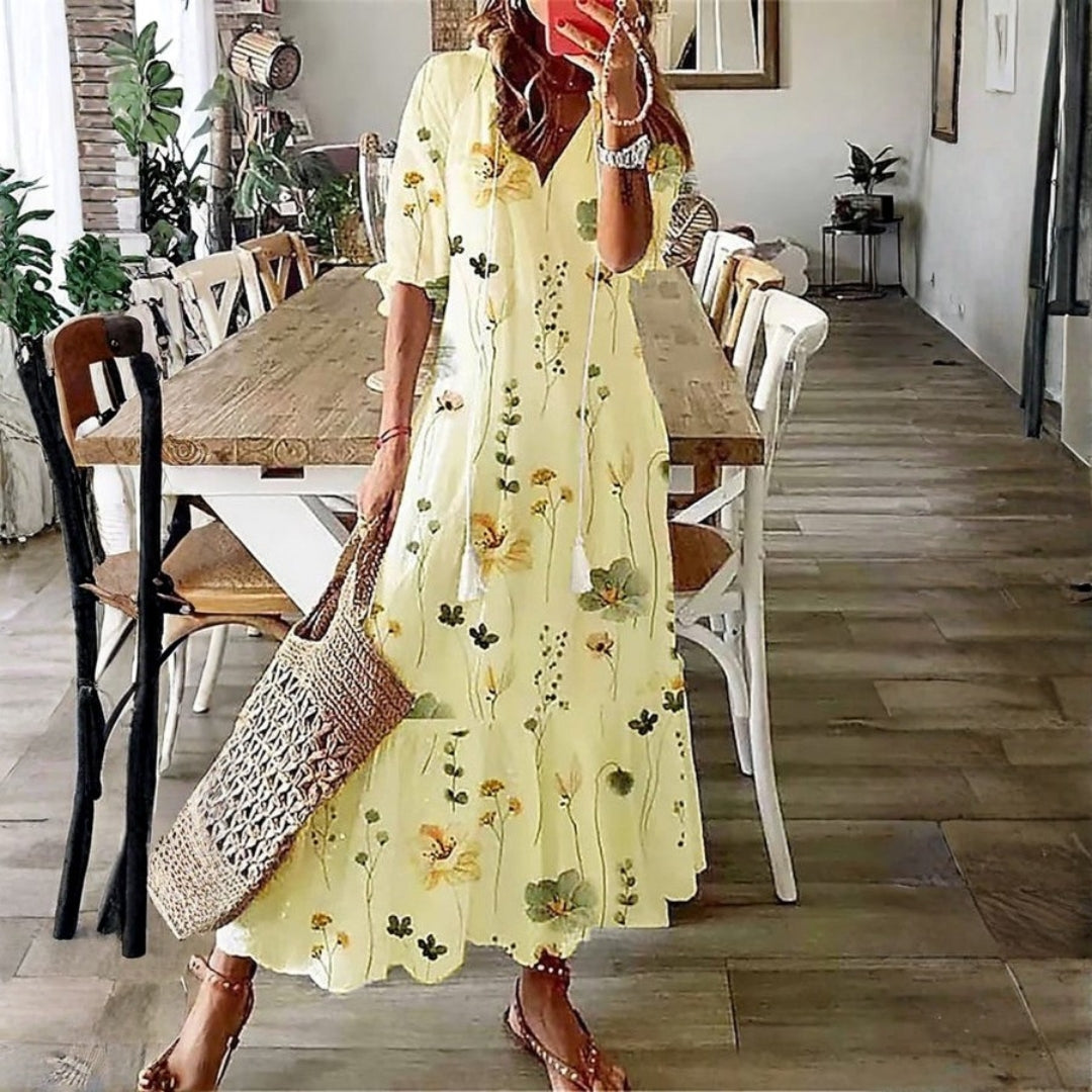 Flowy bohemian maxi dress for women, featuring a vibrant floral print and comfortable short sleeves, ideal for elegant summer.