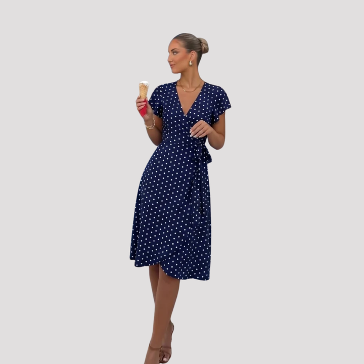Flattering women's V-neck wrap midi dress in a chic polka dot print, ideal as an elegant day or summer dress.